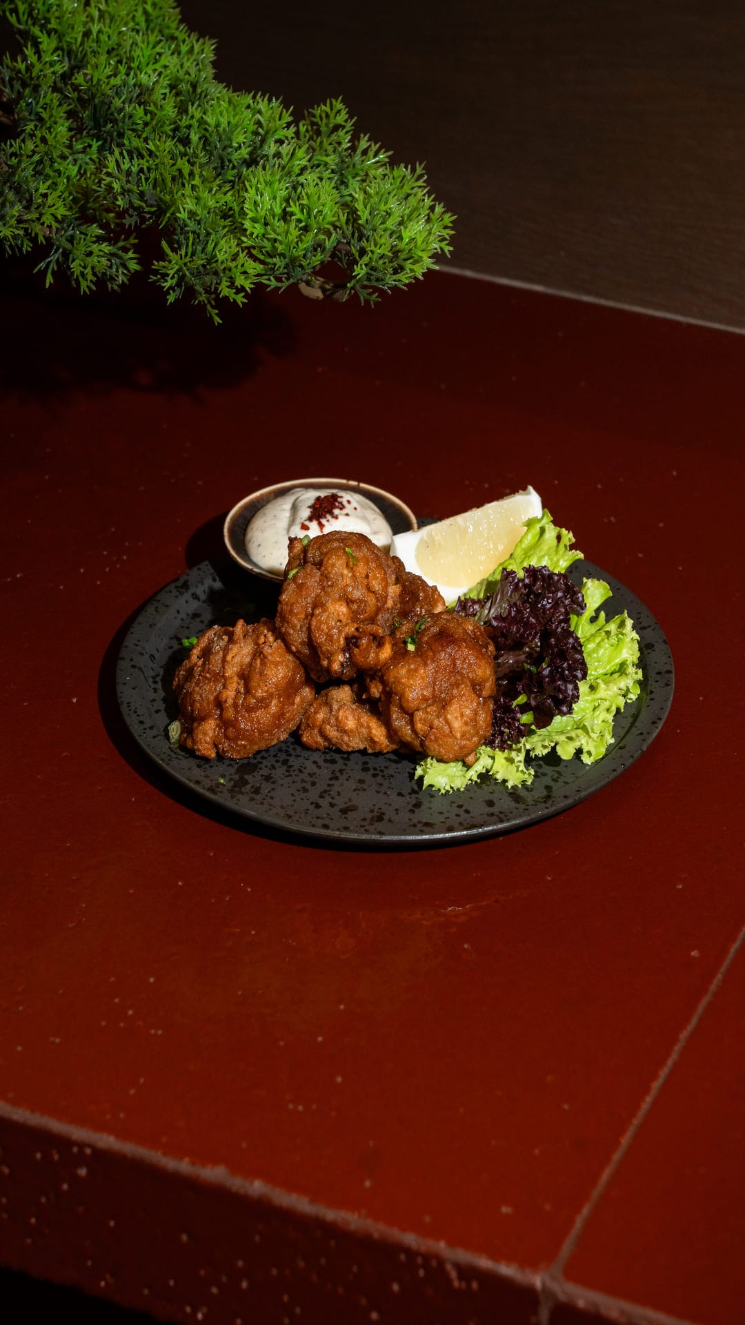 Specially marinated fried chicken served with tartar sauce and a slice of lemon
