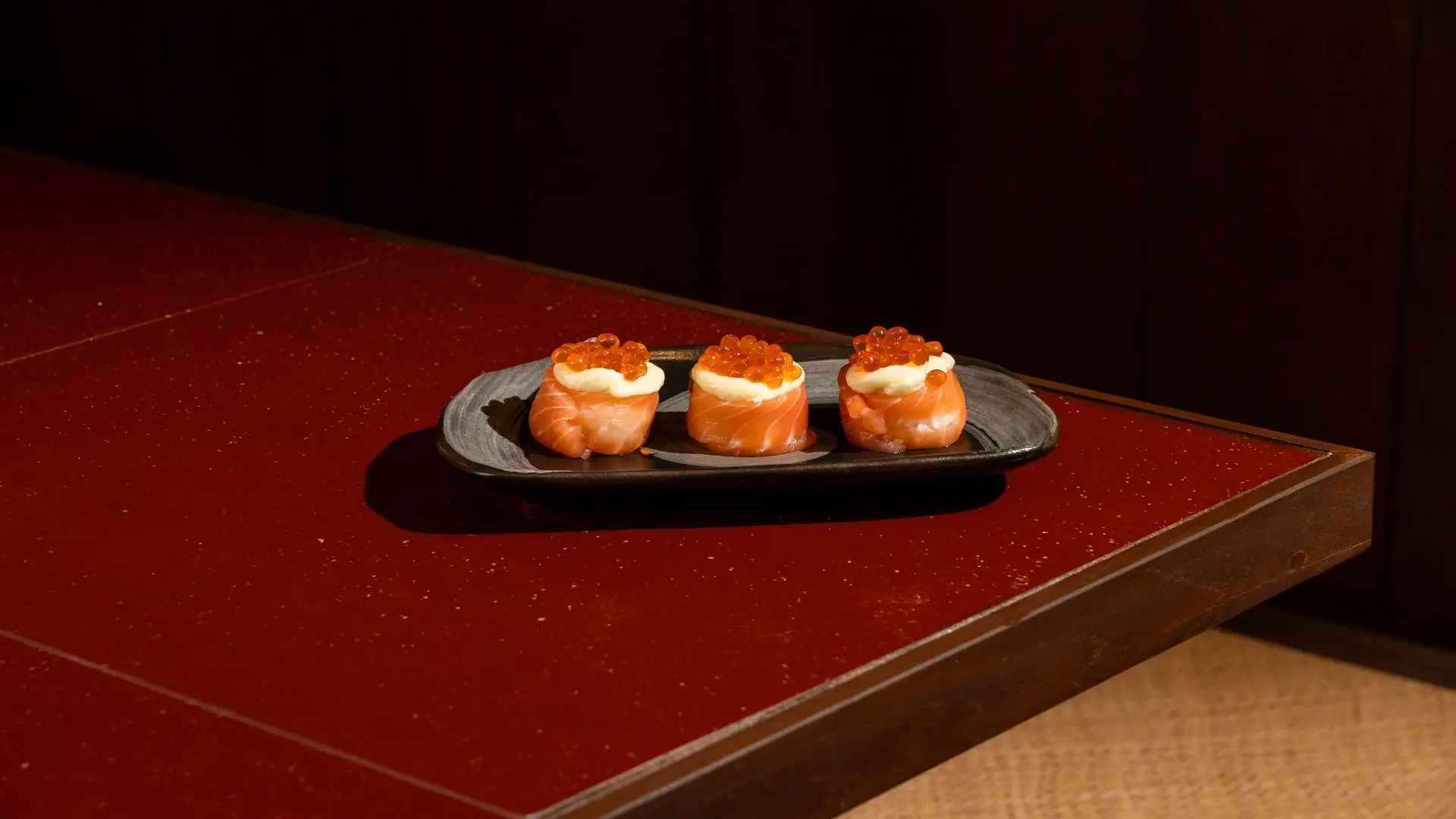Close-up of Hana Salmon Ikura gunkan topped with Fresh Salmon and creamy cheese